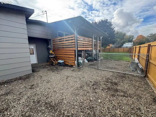 a view of a backyard with wooden fence