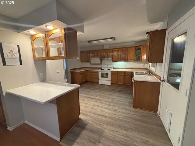 a kitchen that has a lot of cabinets in it and wooden floors