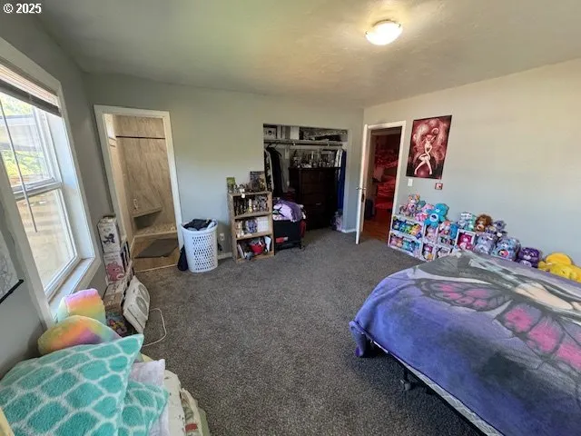 a bedroom with bed and a couch