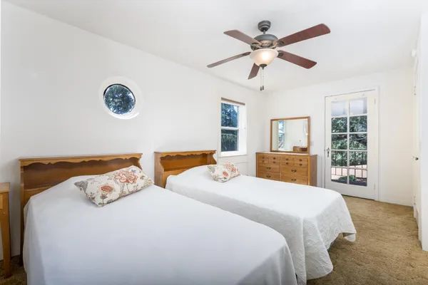 a bed room with two bed and a large window