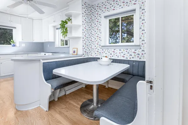 a kitchen with a table chairs sink and window