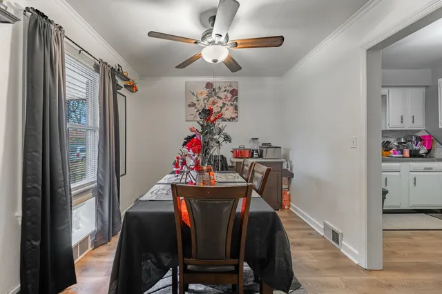 a view of a dining room with furniture and chandelier