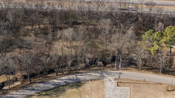 a view of a yard with wooden fence