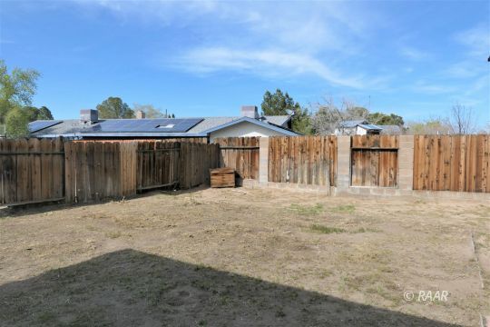 332 Larkspur Street Ridgecrest, CA 93555 - Photo 25 of 28 a front view of a house with a yard and garage