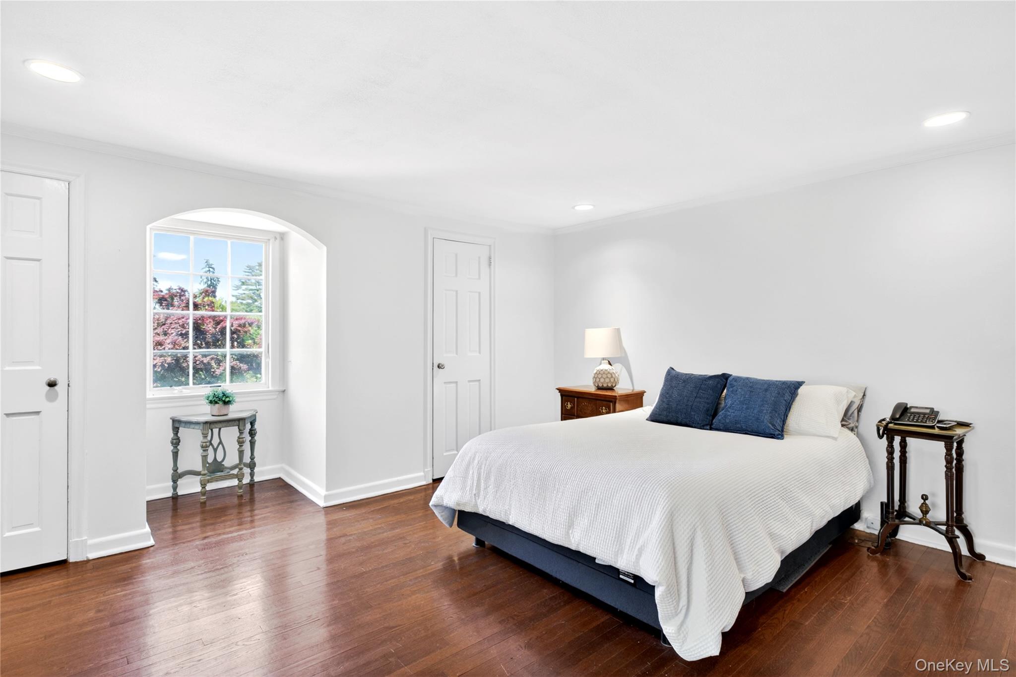 60 Mill Spring Road Manhasset, NY 11030 - Photo 12 of 18 a bedroom with a bed and wooden floor