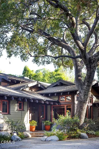 a front view of a house with a garden