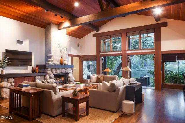 a living room with furniture tv and a large window