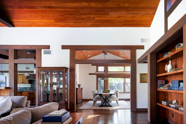 a dining room with furniture window and wooden floor