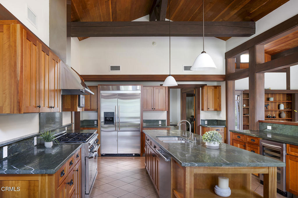 1260 La Loma Road Pasadena, CA 91105 - Photo 27 of 61 a kitchen with stainless steel appliances granite countertop a sink a stove and a wooden cabinets