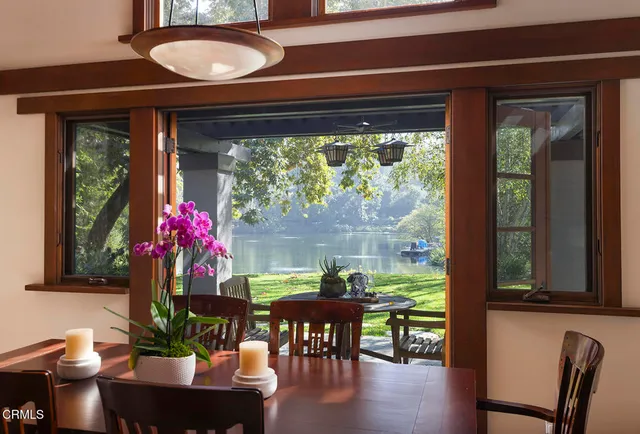 a front view of a house with a yard and potted plant
