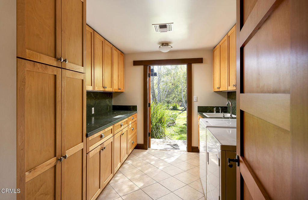 1260 La Loma Road Pasadena, CA 91105 - Photo 31 of 61 a kitchen with a refrigerator a stove top oven and a large window