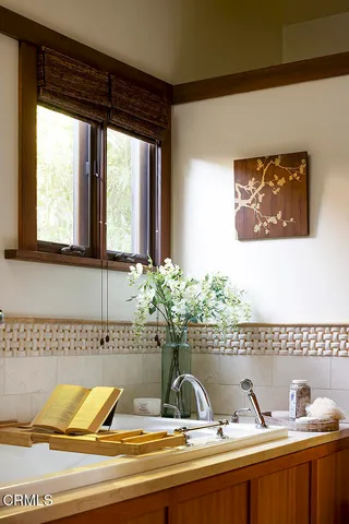 a view of backyard with table and chairs and potted plants