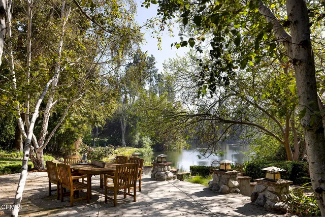 a backyard of a house with table and chairs
