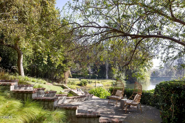 a view of yard with fountain and trees