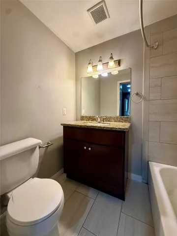 a bathroom with a toilet a sink and a mirror
