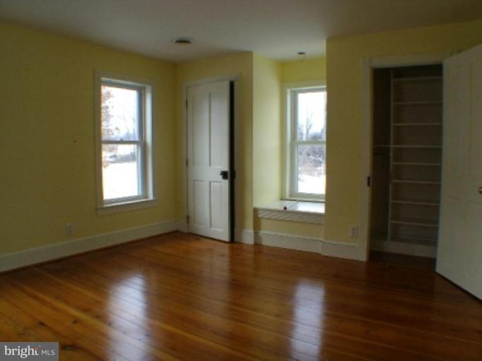 3738 Rittenour Road Woodstock, VA 22664 - Photo 17 of 30 a view of an empty room with wooden floor and a window