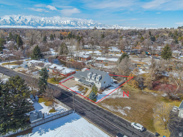 1045 Fox Farm Road Logan, UT 84321 - Photo 65 of 65 Snowy aerial view with property parcel outlined, a residential view, and a mountain view