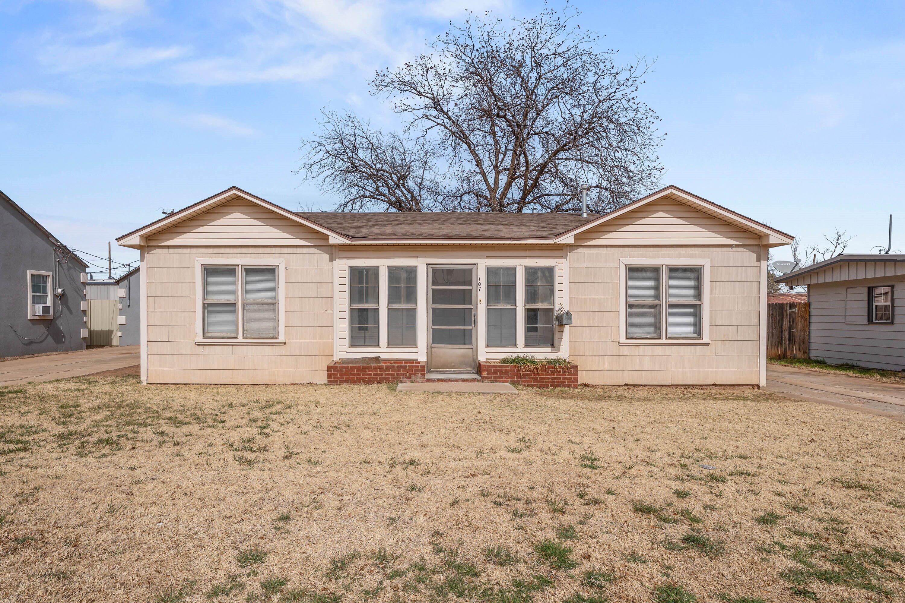 107 Hickory Street Levelland, TX 79336 - Photo 1 of 21 a front view of a house with a garden and yard