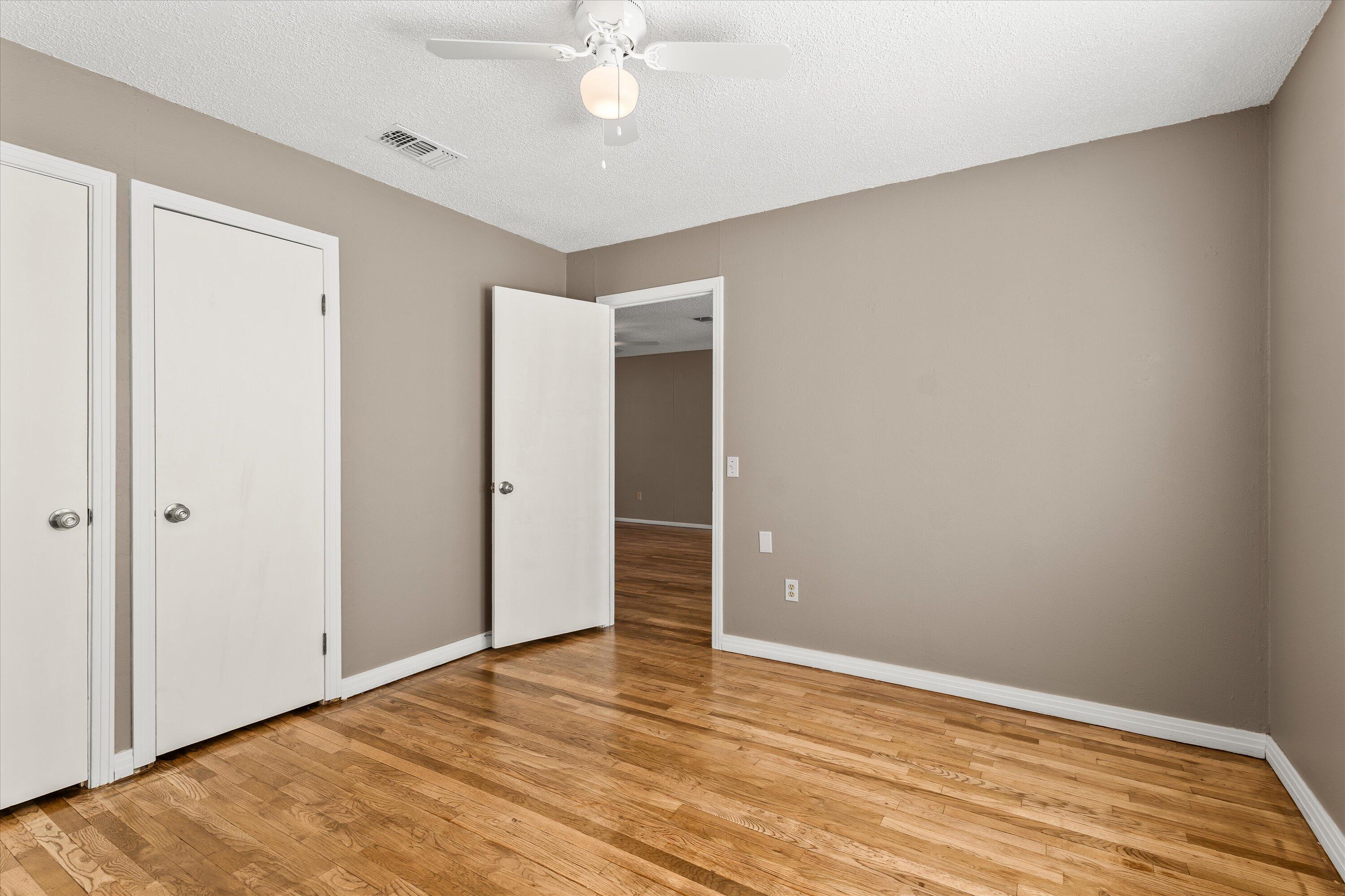 107 Hickory Street Levelland, TX 79336 - Photo 12 of 21 a view of an empty room with wooden floor