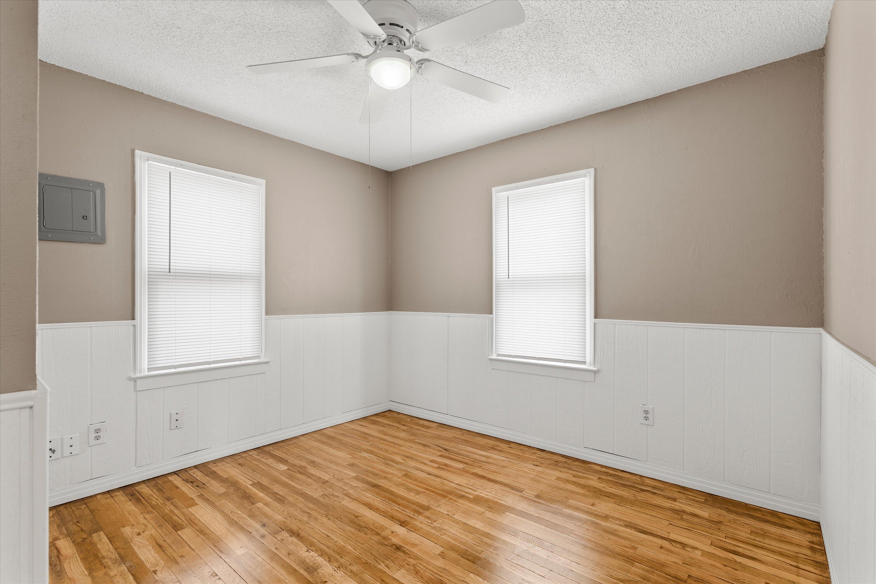 107 Hickory Street Levelland, TX 79336 - Photo 13 of 21 wooden floor in an empty room with a window
