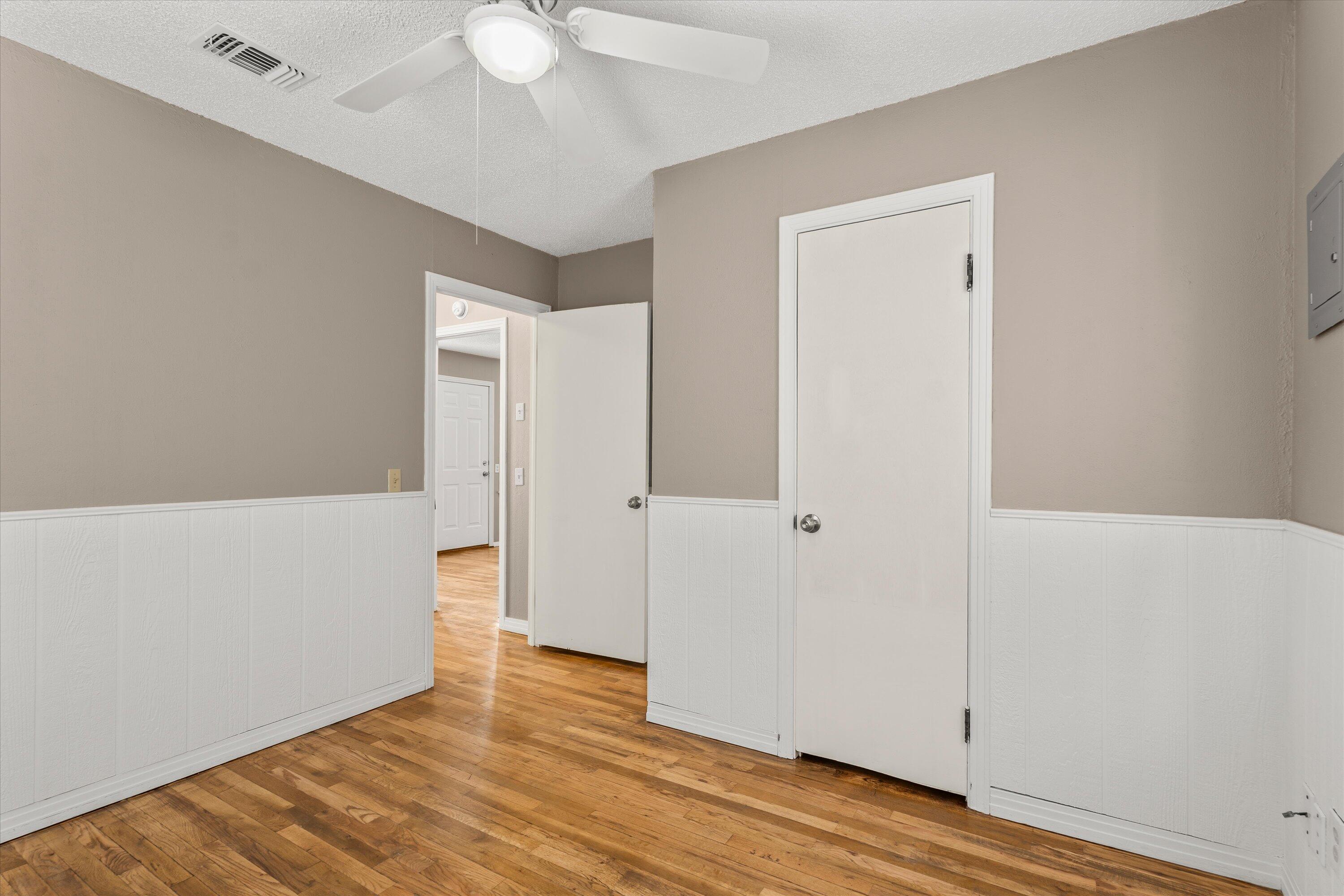 107 Hickory Street Levelland, TX 79336 - Photo 14 of 21 a view of an empty room with wooden floor