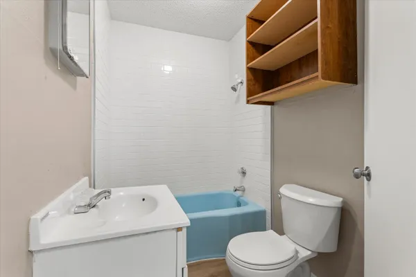 a white toilet sitting next to a bathroom sink