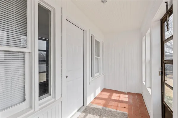 a view of hallway with windows and brick walls