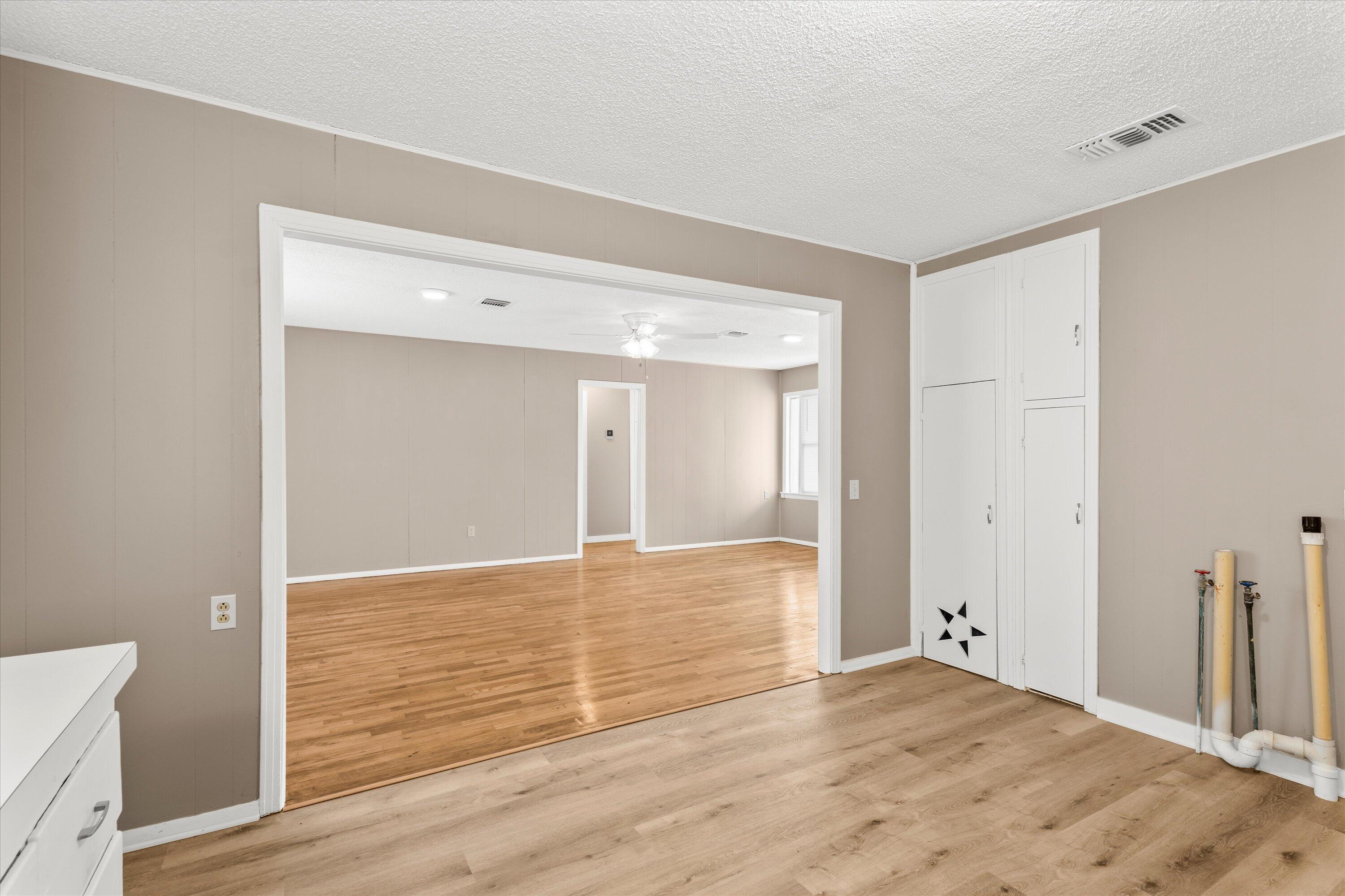107 Hickory Street Levelland, TX 79336 - Photo 10 of 21 a view of an empty room with wooden floor