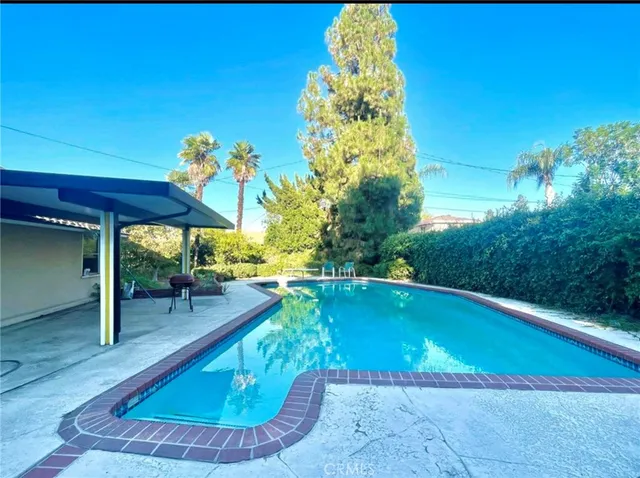 a view of a swimming pool with a patio