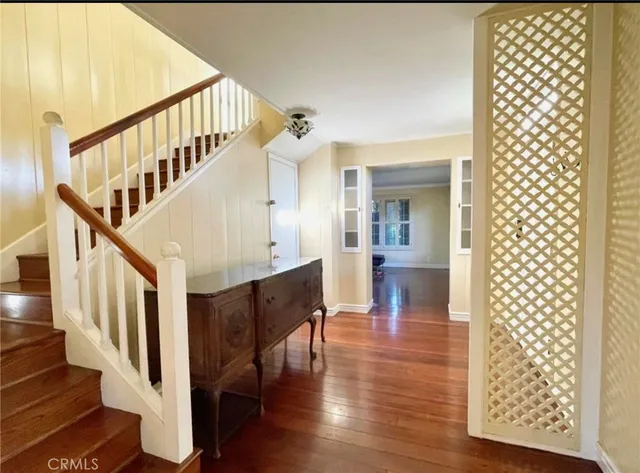a view of entryway and hall with wooden floor