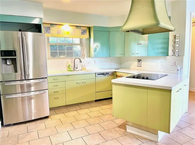 a kitchen with a sink cabinets and stainless steel appliances