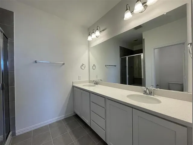 a bathroom with a sink double vanity and a mirror