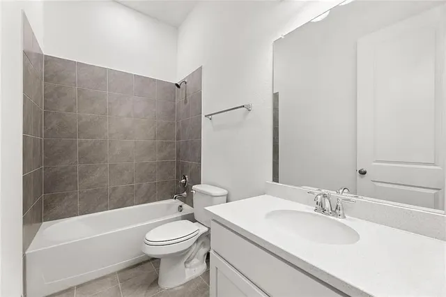 a bathroom with a sink a toilet and bathtub