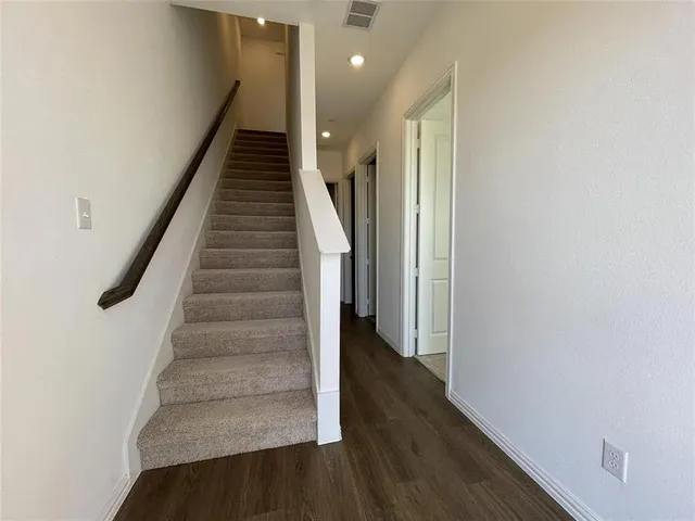 a view of entryway and hall with wooden floor