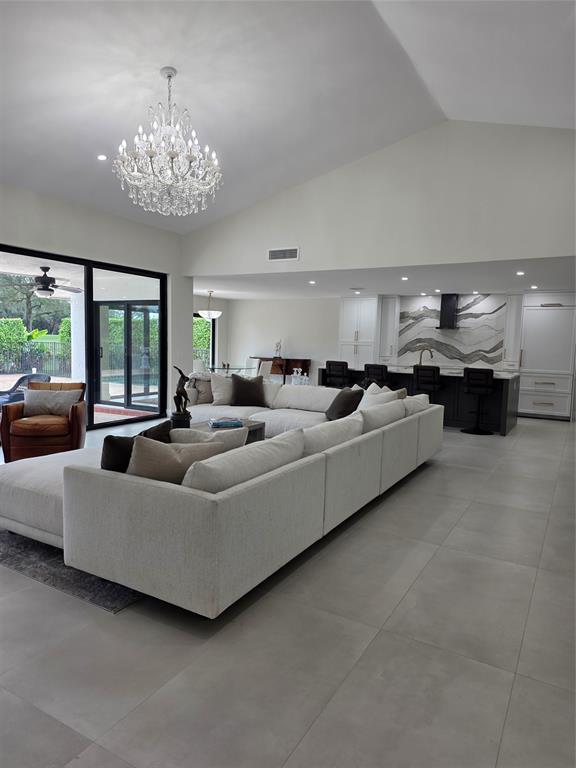 a living room with furniture and a chandelier