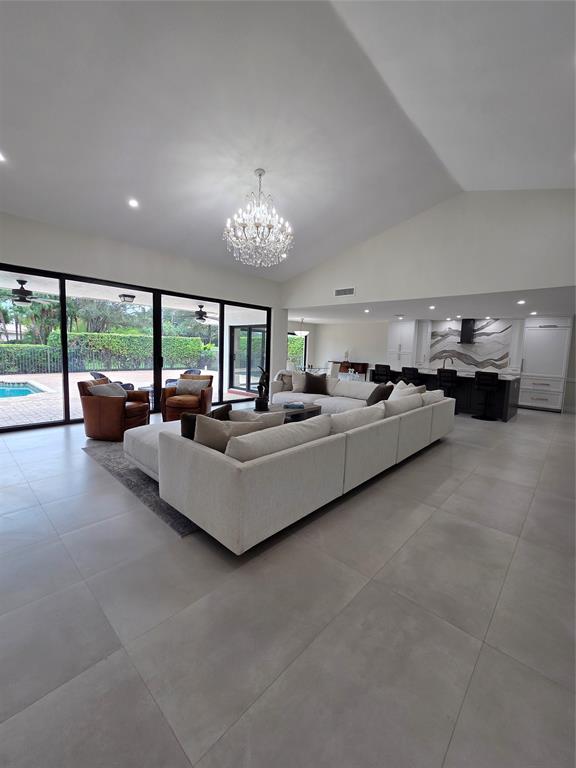 10486 Boca Woods Lane Boca Raton, FL 33428 - Photo 12 of 18 a living room with furniture and a large window