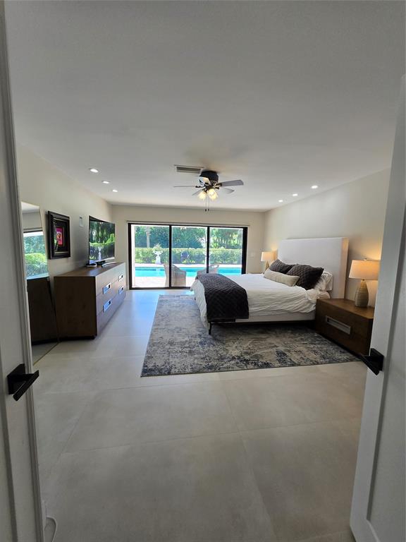 10486 Boca Woods Lane Boca Raton, FL 33428 - Photo 7 of 18 a living room with furniture and a flat screen tv