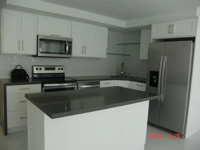 a kitchen with a sink and a refrigerator