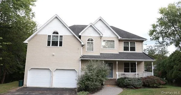 a view of a white house next to a yard