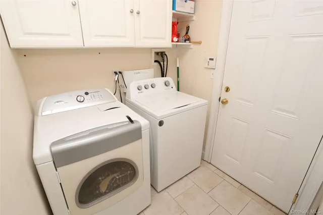 a kitchen with kitchen island granite countertop stainless steel appliances and view of living room