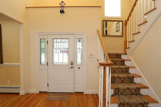 a view of a livingroom with wooden floor and stairs