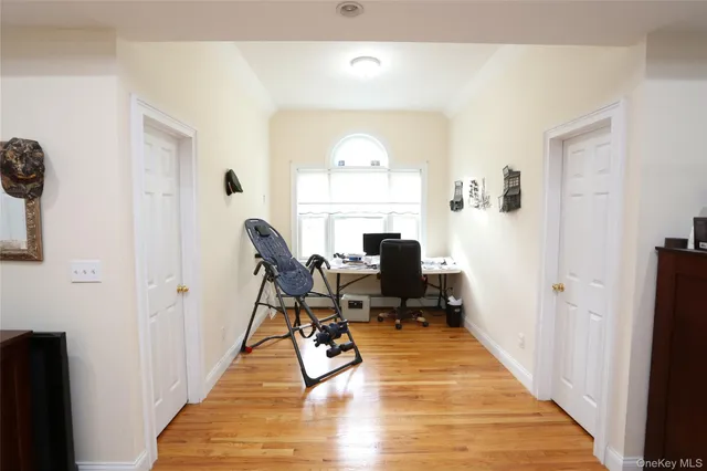 a view of a workspace with furniture and a window