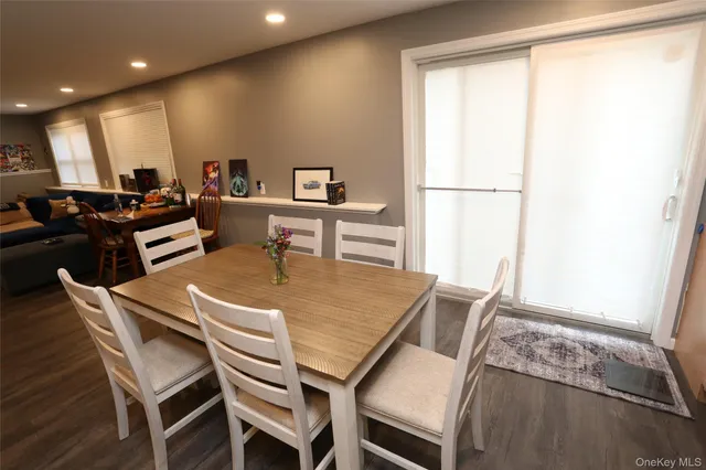 a view of a dining room with furniture and a window