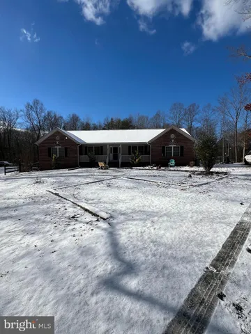a view of large space with a house in the background