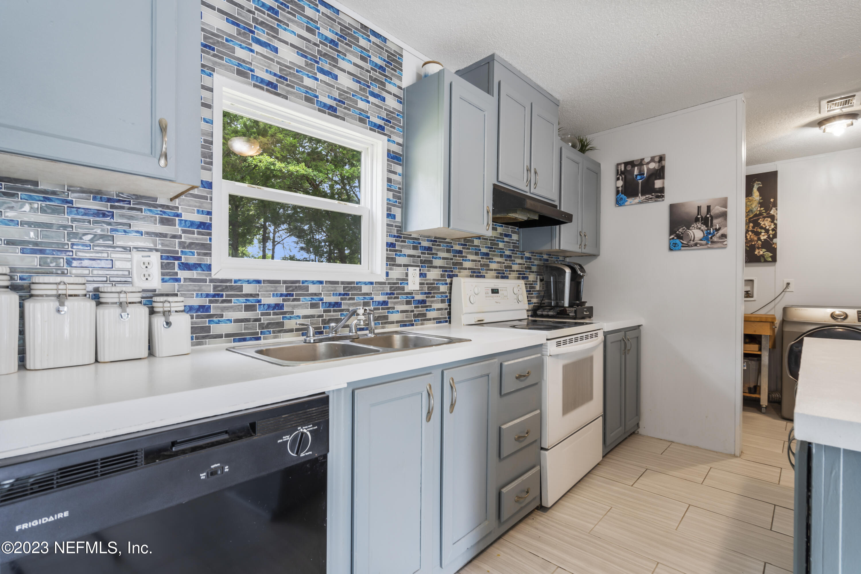 198 Yellow Water Road Baldwin, FL 32234 - Photo 12 of 37 a kitchen with a sink cabinets and window
