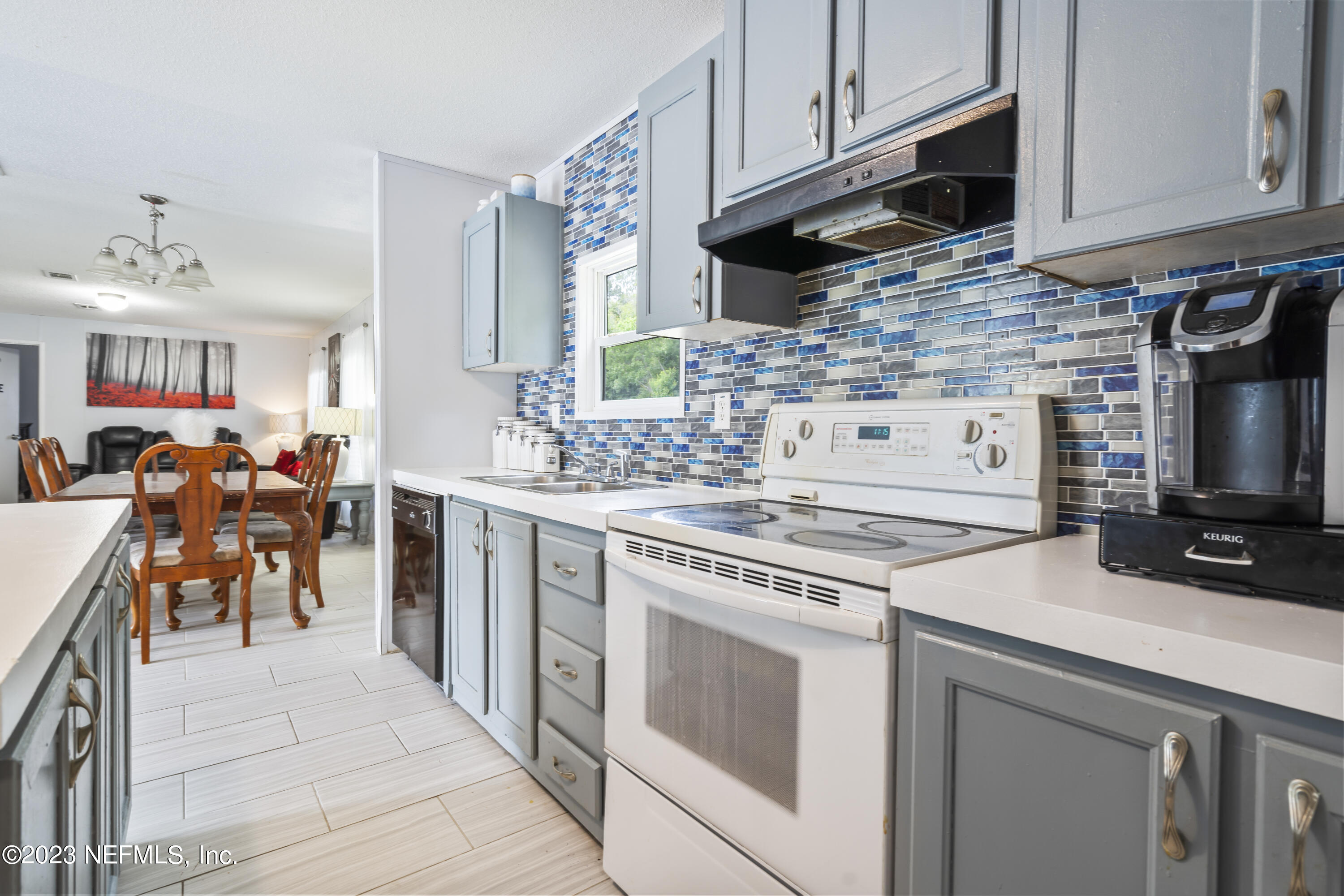 198 Yellow Water Road Baldwin, FL 32234 - Photo 13 of 37 a kitchen with stainless steel appliances a stove a sink a stove and cabinets