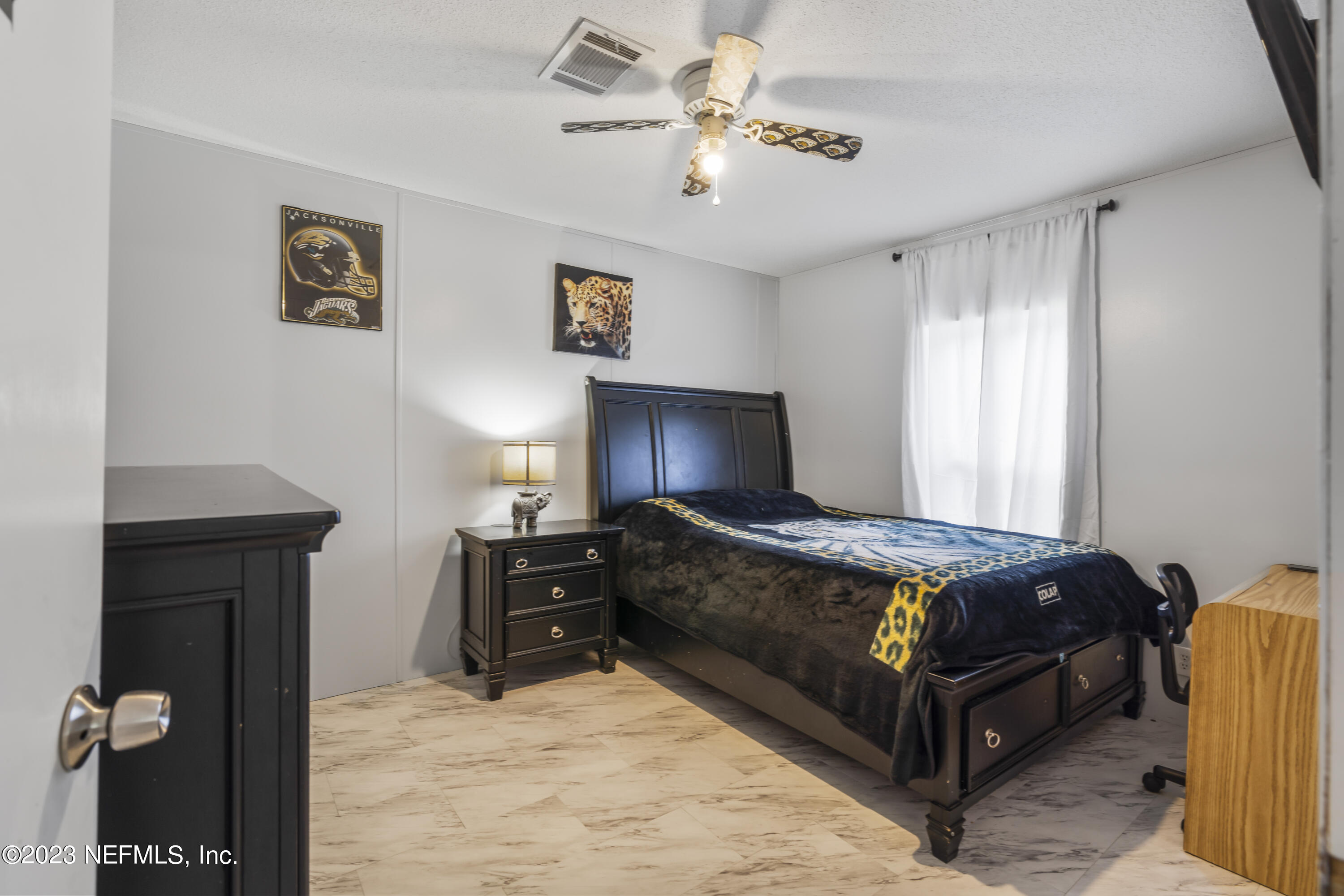 198 Yellow Water Road Baldwin, FL 32234 - Photo 15 of 37 a bedroom with a bed and a chandelier