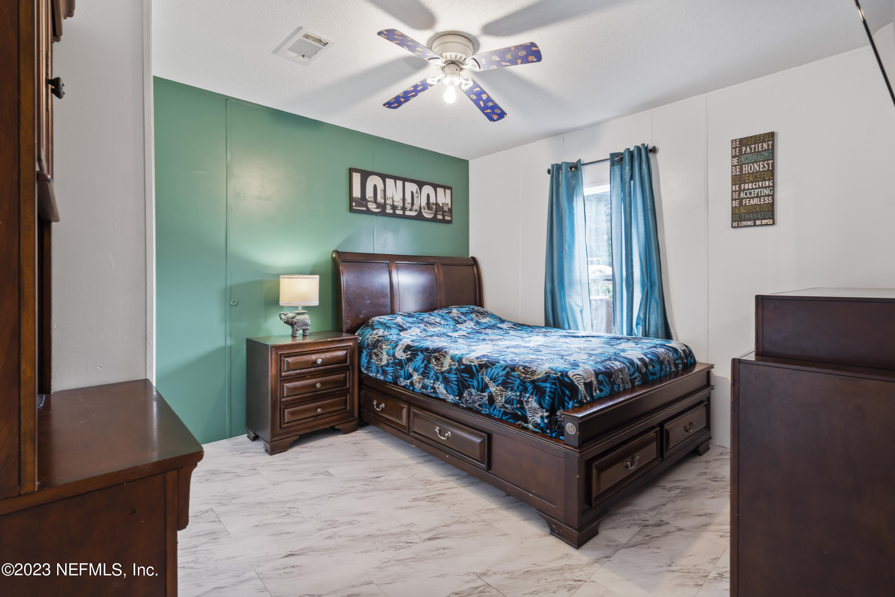 198 Yellow Water Road Baldwin, FL 32234 - Photo 17 of 37 a bedroom with a bed lamp and a chandelier