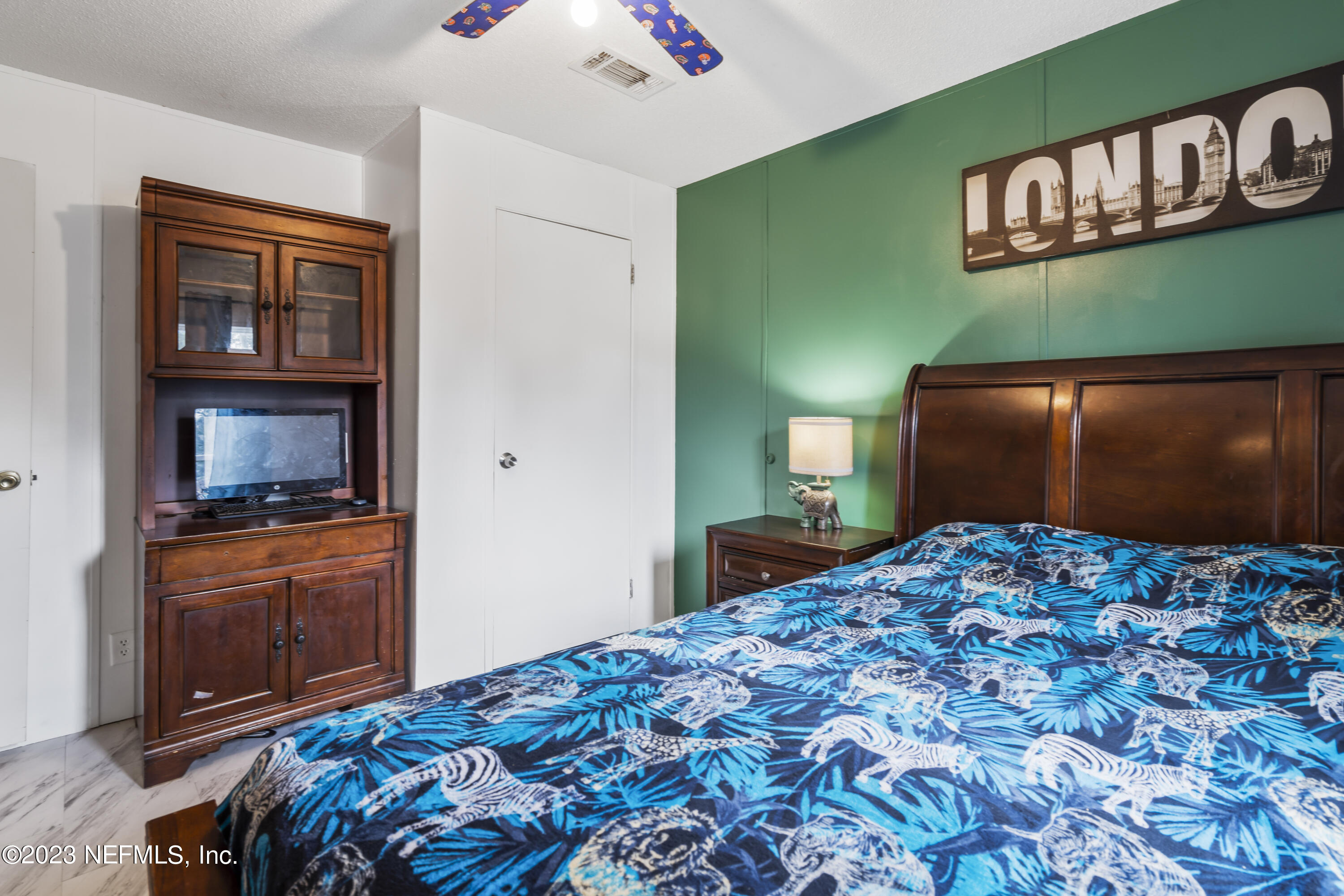 198 Yellow Water Road Baldwin, FL 32234 - Photo 18 of 37 a bedroom with a bed and dresser