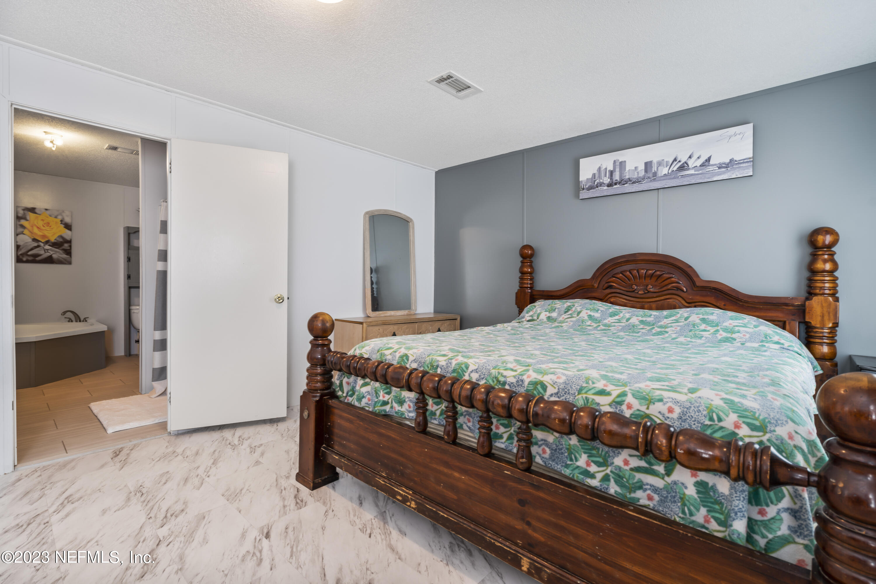 198 Yellow Water Road Baldwin, FL 32234 - Photo 23 of 37 a bedroom with a bed and wooden floor